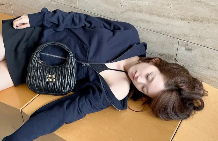 Black Miu Miu Wander Hobo replica carried stylishly by model in street style outfit